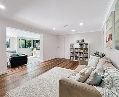 Spacious living area with modern finishes, large windows, and an inviting atmosphere perfect for relaxation.