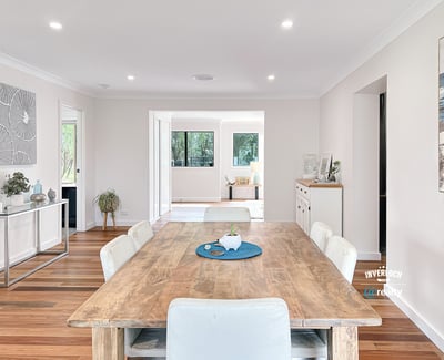 Spacious open-concept living area featuring a modern dining space and abundant natural light throughout.