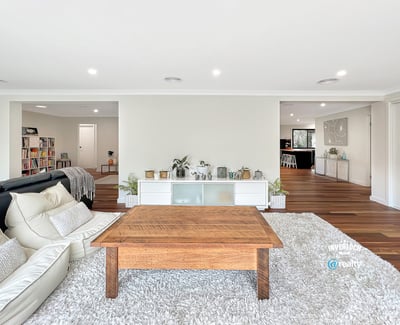 Spacious living area with modern design, featuring abundant light and seamless flow to adjacent rooms.