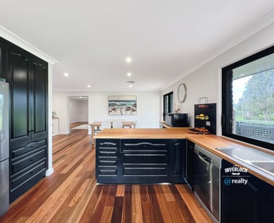 Modern kitchen featuring rich wood accents, ample counter space, and an open layout perfect for entertaining.