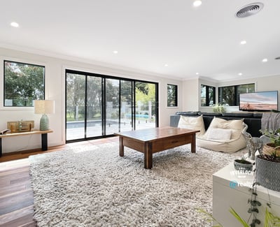 Spacious living area featuring large windows, modern furnishings, and seamless indoor-outdoor flow for relaxation and entertainment.