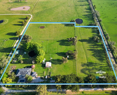 Expansive property featuring lush pastures and water features, perfect for agricultural pursuits or private retreat.