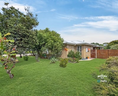 This inviting home features a spacious yard, surrounded by lush greenery and abundant natural light.