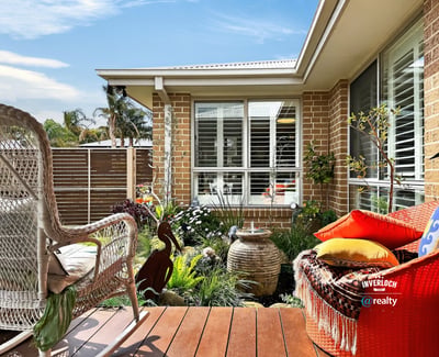 Discover a cozy outdoor space featuring lush landscaping, perfect for relaxation and outdoor gatherings.