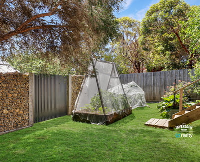 This spacious outdoor area features a productive garden and cozy relaxation spots surrounded by greenery.