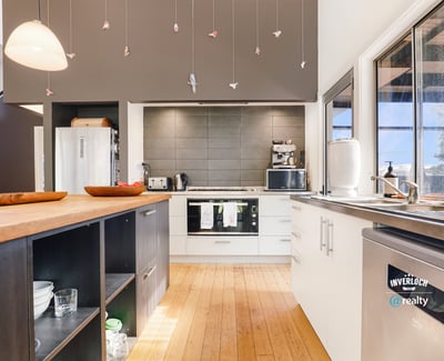 Contemporary kitchen featuring modern appliances, spacious countertops, and unique decorative accents for a vibrant cooking space.