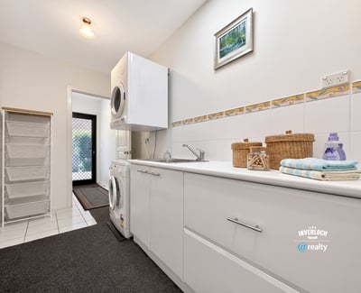 Bright and functional laundry room featuring modern appliances and ample storage for all your needs.