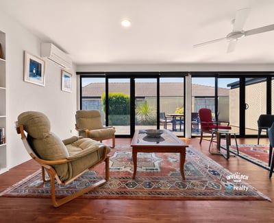 Bright, open living space featuring large windows, versatile furnishings, and a spacious outdoor view.