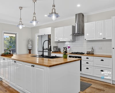 Discover this modern kitchen featuring a spacious island, sleek appliances, and abundant natural light.