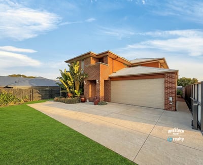 Spacious two-story home with a well-maintained lawn, perfect for family living and outdoor activities.