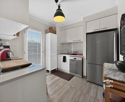 Modern kitchen featuring sleek appliances, ample storage, and natural light, perfect for culinary enthusiasts.