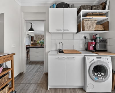 Bright and functional laundry area featuring modern appliances and ample storage for convenience and organization.