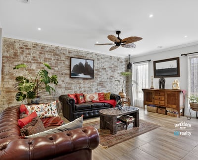 Discover a unique living space featuring exposed brick, vibrant textiles, and natural light, perfect for relaxation.