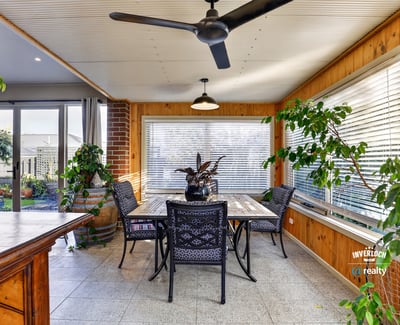 Bright and airy sunroom features large windows, perfect for enjoying peaceful views and entertaining guests.