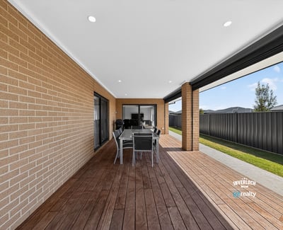 Spacious outdoor patio area perfect for entertaining, featuring a modern design and low-maintenance landscaping.