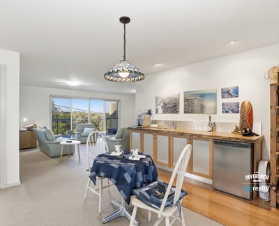 Bright, open-plan living space seamlessly connects the kitchen, dining, and cozy lounge area, perfect for entertaining.