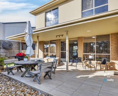 Enjoy outdoor living in this spacious backyard, featuring a patio and ample space for entertaining.