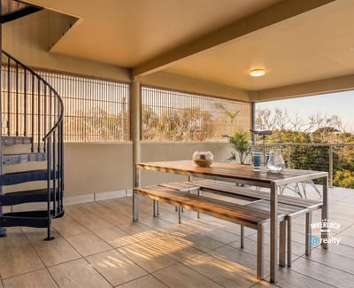 Spacious outdoor terrace featuring a spiral staircase, perfect for entertaining and enjoying panoramic views.