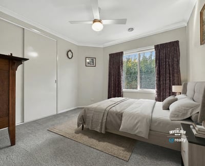 Bright bedroom featuring a cozy layout, large window, and ample storage for a comfortable living experience.