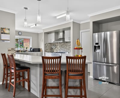 Modern kitchen featuring sleek appliances, ample counter space, and a breakfast bar perfect for gatherings.