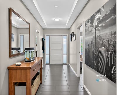 Spacious entryway featuring contemporary decor, natural light, and functional layout for welcoming guests.