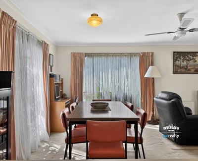 Bright and inviting living space featuring large windows, a dining area, and comfortable seating for relaxation.