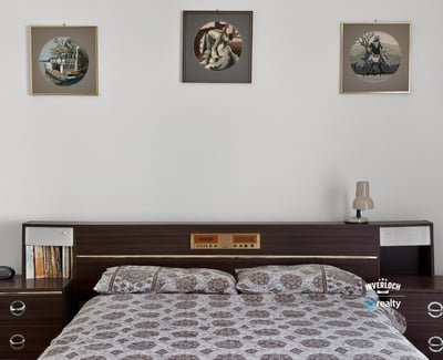 Cozy bedroom featuring vintage decor, modern furnishings, and ample natural light, perfect for relaxation.