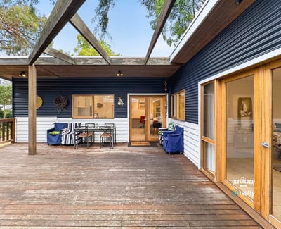 Spacious deck perfect for outdoor entertaining, seamlessly blends indoor and outdoor living in a picturesque setting.
