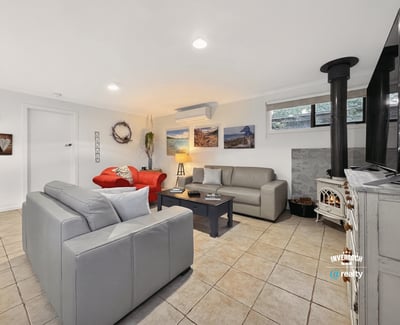 Bright and inviting living space featuring modern furnishings and a cozy fireplace, perfect for relaxation.