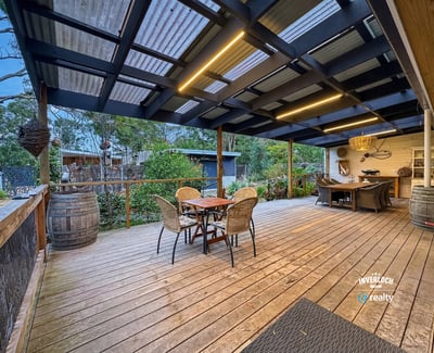 Discover this inviting outdoor space, perfect for entertaining and surrounded by lush greenery and tranquility.
