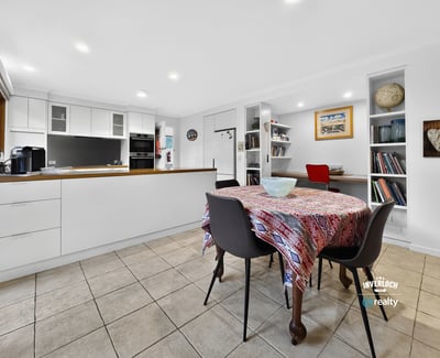 Bright and inviting kitchen and dining area, featuring modern finishes and ample storage space.