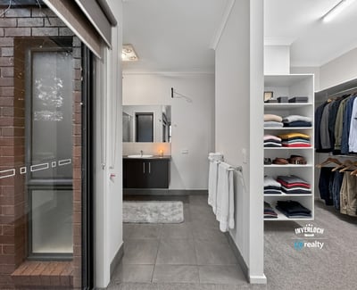 Modern bathroom with a spacious walk-in closet, featuring ample storage for an organized lifestyle.