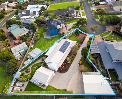Spacious property featuring a large outdoor area and solar panels, nestled in a modern neighborhood.