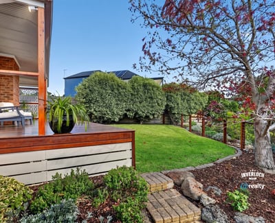 Inviting outdoor space with landscaped garden and seating area, perfect for relaxation and entertaining.