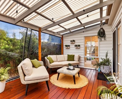 Inviting sunroom featuring comfortable seating, lush greenery, and abundant natural light for relaxed gatherings.