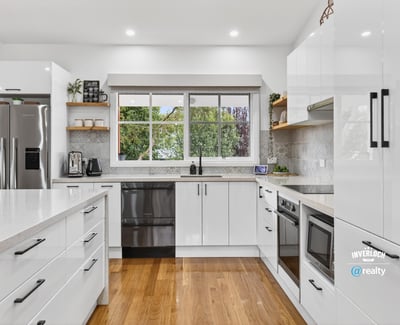 Modern kitchen featuring sleek cabinetry, stainless steel appliances, and abundant natural light for an inviting atmosphere.