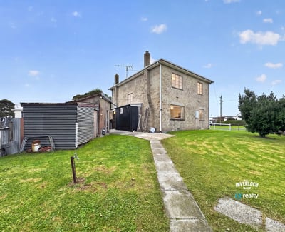 Spacious two-story home with a large yard, ideal for customization and outdoor activities.