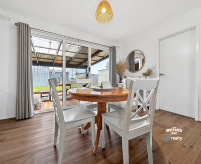 Bright dining area with outdoor access, perfect for enjoying meals and entertaining in a spacious layout.
