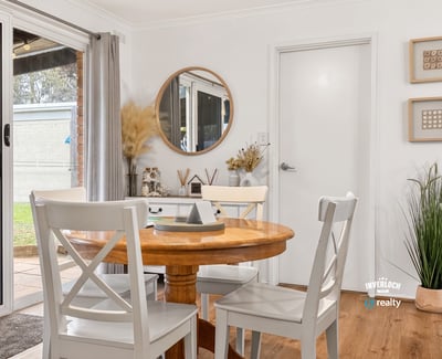 Bright dining area featuring natural light, modern decor, and easy access to outdoor space.
