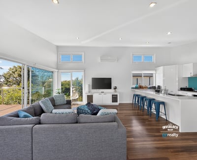 Bright, open-concept living space featuring modern design, large windows, and a seamless flow to outdoor views.
