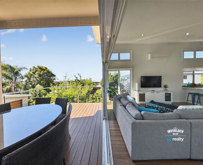 Bright and spacious indoor-outdoor living area with scenic views, perfect for entertaining and relaxation.