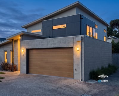 Modern two-story home featuring large windows, contemporary design, and convenient garage access in a vibrant neighborhood.