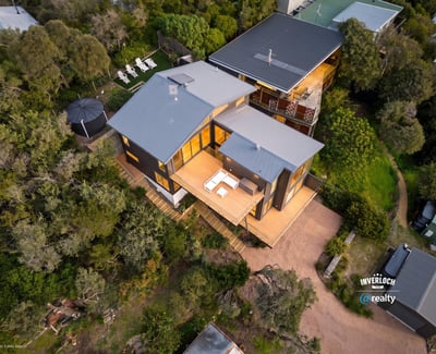 Spacious contemporary home nestled in nature, featuring expansive outdoor living areas and stunning views.