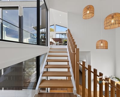 Contemporary design meets natural light in this spacious staircase, highlighting a seamless transition between levels.