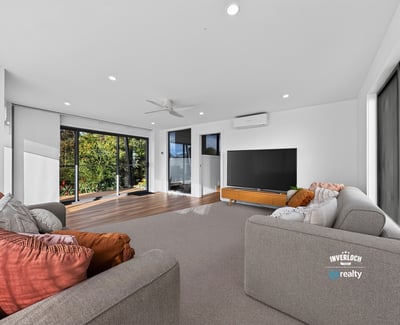 Bright and spacious living area with large windows, offering panoramic views and seamless indoor-outdoor flow.