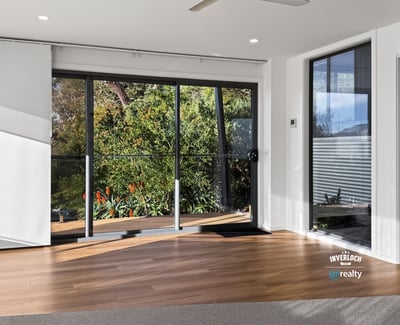 Bright and airy living space with large windows that offer stunning views of the outdoors.