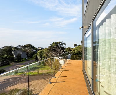 Contemporary outdoor space offers panoramic views, ideal for relaxation or entertaining in a coastal setting.