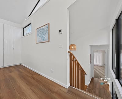 Bright and open foyer with modern design, leading to spacious living areas and stylish staircase.