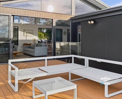 Bright outdoor living space seamlessly connects to an inviting open-plan interior, perfect for entertaining and relaxation.