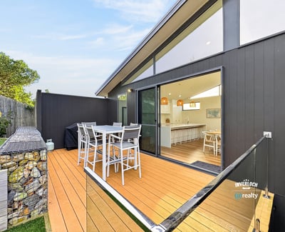 Spacious outdoor deck seamlessly connects to an airy indoor living space, perfect for entertaining and relaxation.